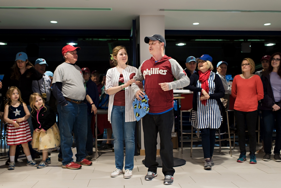 A newly married couple thanking their guests for coming to their wedding at the Phillies game.